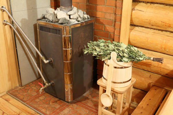 a-bucket-birch-broom-oven-and-other-accessories-are-in-the-sauna